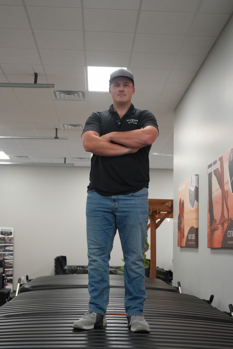 McAndrew Hot Tubs team member standing on the Arlington showroom floor